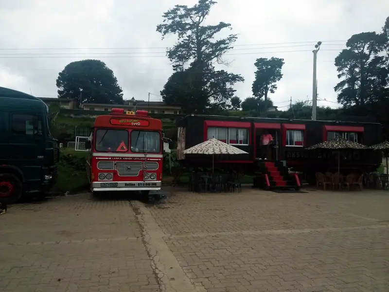 Restaurant Two's red bus, truck and dining car with umbrellas and outdoor tables