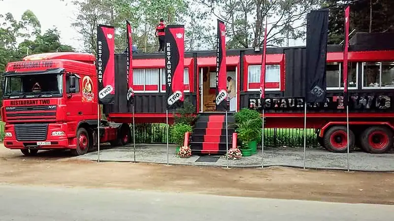Restaurant Two's red DAF truck and black-and-red container dining car on the roadside in Nuwara Eliya